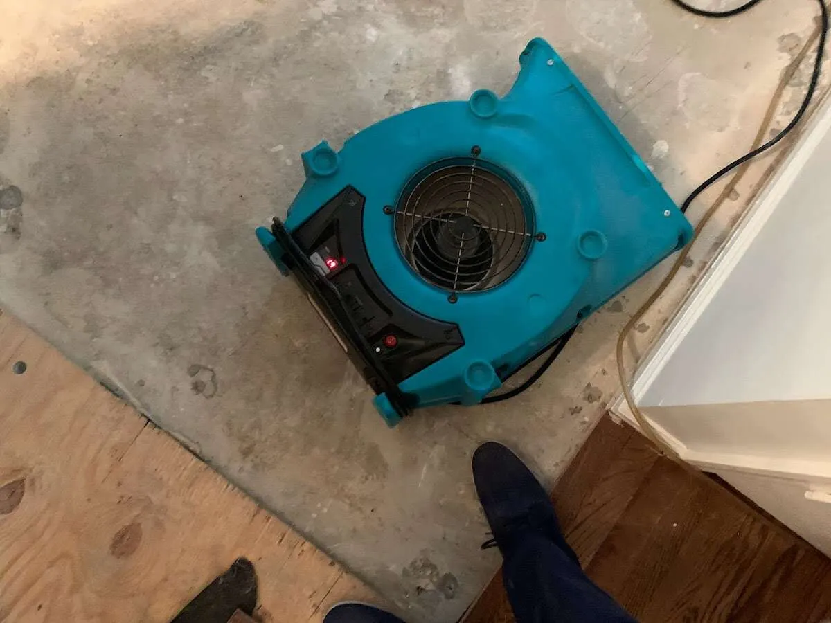 Air mover drying subfloor during Commercial Water Damage Restoration in St. Francis